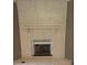 Unique fireplace with stone surround and a decorative shelf at 905 Ohara Dr, Jonesboro, GA 30236