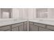 Bright bathroom boasting double sinks with white marble countertops and modern gray cabinetry at 340 Sound Cir, Stockbridge, GA 30281