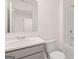 A well-lit bathroom featuring a modern sink, marble countertop, and a sleek, white toilet and shower combination at 340 Sound Cir, Stockbridge, GA 30281