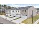 Rear view of modern townhomes featuring attached garages, gray siding, and well-maintained lawns at 340 Sound Cir, Stockbridge, GA 30281