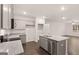 Open kitchen boasts gray cabinets, island with sink, and stainless dishwasher at 340 Sound Cir, Stockbridge, GA 30281