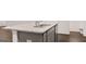 Kitchen island with granite countertop, stainless sink and gray cabinets at 340 Sound Cir, Stockbridge, GA 30281