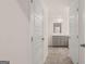 Bright bathroom featuring gray cabinetry, white marble countertops, and a tiled floor at 348 Sound Cir, Stockbridge, GA 30281