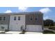 Beautiful townhouse showcasing modern design elements and attached one-car garages at 352 Sound Cir, Stockbridge, GA 30281