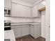 Well-designed kitchen with stainless steel appliances, granite countertops, and gray cabinetry at 352 Sound Cir, Stockbridge, GA 30281