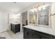Elegant bathroom with marble countertops, dark cabinetry, and modern lighting fixtures, providing a luxurious and functional space at 4645 Villa Ridge Ne Rd, Marietta, GA 30068