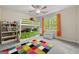 Bright bedroom with a bunk bed, colorful rug, and a window that offers natural light at 4645 Villa Ridge Ne Rd, Marietta, GA 30068