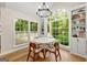 Eat-in kitchen nook with large windows, a chandelier, and built-in shelving perfect for dining at 4645 Villa Ridge Ne Rd, Marietta, GA 30068