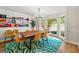 Bright dining room with a wooden table, colorful rug, and large windows that let in natural light at 4645 Villa Ridge Ne Rd, Marietta, GA 30068