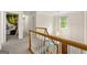 Bright hallway with wood and white banister, and a charming light fixture illuminates the staircase and entryway at 4645 Villa Ridge Ne Rd, Marietta, GA 30068