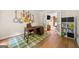 Bright home office features hardwood floors, a work desk, and french doors leading to the living room at 4645 Villa Ridge Ne Rd, Marietta, GA 30068