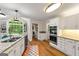 Well-lit kitchen with granite countertops, stainless steel appliances, eat-in nook, and hardwood floors at 4645 Villa Ridge Ne Rd, Marietta, GA 30068