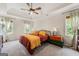 Cozy main bedroom featuring a tray ceiling, windows, and a ceiling fan for comfort and relaxation at 4645 Villa Ridge Ne Rd, Marietta, GA 30068