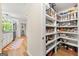 Organized walk-in pantry with custom shelving and ample storage space, conveniently located near the kitchen and laundry at 4645 Villa Ridge Ne Rd, Marietta, GA 30068