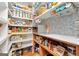 Spacious walk-in pantry features custom shelving, countertop space, and stylish wallpaper for functional storage at 4645 Villa Ridge Ne Rd, Marietta, GA 30068