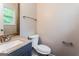 Well-lit bathroom features modern fixtures, a granite countertop vanity, and neutral wall colors at 64 Acorn Dr, Dallas, GA 30157