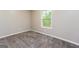Bright bedroom with plush carpeting and a window offering natural light and backyard views at 64 Acorn Dr, Dallas, GA 30157