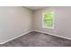 Inviting bedroom with cozy carpeting and a window that fills the space with natural light at 64 Acorn Dr, Dallas, GA 30157