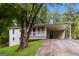 Charming single-Gathering home featuring a spacious carport, inviting front porch, and well-maintained landscaping at 64 Acorn Dr, Dallas, GA 30157
