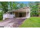 The exterior features a convenient carport for parking, a charming front porch, and a well-manicured lawn at 64 Acorn Dr, Dallas, GA 30157