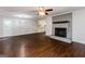 The spacious room showcases a painted brick fireplace, modern ceiling fan, and an open layout at 64 Acorn Dr, Dallas, GA 30157