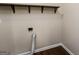 Functional utility area features shelving for organization and necessary hookups for appliances at 64 Acorn Dr, Dallas, GA 30157