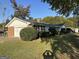 Charming home with a brick garage, well-manicured shrubs, and a lush green lawn on a sunny day at 4634 Bexley Dr, Stone Mountain, GA 30083