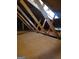 View of the attic with wooden beams, plywood floor and natural light at 2118 Cherry Tree Ln, Peachtree City, GA 30269