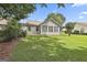 Backyard with a well-maintained lawn and lush landscaping providing a serene outdoor space at 2118 Cherry Tree Ln, Peachtree City, GA 30269