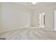 A clean, spacious bedroom featuring neutral carpet, bright white walls and trim, plus a modern ceiling fan at 2118 Cherry Tree Ln, Peachtree City, GA 30269