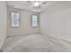 A spacious bedroom with neutral carpet, ceiling fan and natural light at 2118 Cherry Tree Ln, Peachtree City, GA 30269