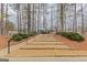 Community common area with benches and a walkway among the trees at 2118 Cherry Tree Ln, Peachtree City, GA 30269