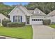 Charming one-story home features a well-manicured lawn, garage and beautiful shutters at 2118 Cherry Tree Ln, Peachtree City, GA 30269
