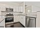 Close-up view of a modern kitchen with stainless steel appliances and granite countertops at 2118 Cherry Tree Ln, Peachtree City, GA 30269