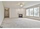 Spacious living room featuring plush carpeting and a cozy fireplace at 2118 Cherry Tree Ln, Peachtree City, GA 30269