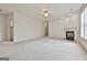 A roomy living area features plush carpeting and a charming fireplace at 2118 Cherry Tree Ln, Peachtree City, GA 30269