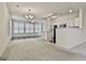 Bright, open living room with hardwood floors in the sunroom and stainless steel appliances in the kitchen at 2118 Cherry Tree Ln, Peachtree City, GA 30269