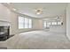 Spacious living room featuring plush carpeting and a modern fireplace at 2118 Cherry Tree Ln, Peachtree City, GA 30269