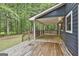 Spacious covered back deck with wood flooring and railings, offering a relaxing outdoor space at 270 Carrolls Way, Fayetteville, GA 30215