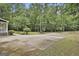 The driveway extends into the wooded area surrounding the home at 270 Carrolls Way, Fayetteville, GA 30215