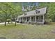 Charming home with a full covered front porch, dormer windows, and lush lawn at 270 Carrolls Way, Fayetteville, GA 30215