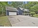Exterior view showcasing home and detached garage with paved driveway at 270 Carrolls Way, Fayetteville, GA 30215