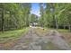 View of home and garage, surrounded by a lush, green treeline at 270 Carrolls Way, Fayetteville, GA 30215