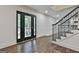 Inviting foyer with a staircase, hardwood floors, and natural light streaming through the glass-paneled front door at 270 Carrolls Way, Fayetteville, GA 30215