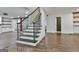 Open concept living space featuring hardwood floors, elegant staircase, and seamless flow to other rooms at 270 Carrolls Way, Fayetteville, GA 30215