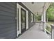 Inviting front porch with gray flooring and exterior, featuring a black front door and ample natural light at 270 Carrolls Way, Fayetteville, GA 30215