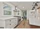 Bright kitchen featuring stainless steel appliances, white cabinets, and a view of the backyard at 270 Carrolls Way, Fayetteville, GA 30215
