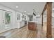 Modern kitchen with white cabinets, stainless appliances, kitchen island, and sliding glass doors to the outside deck at 270 Carrolls Way, Fayetteville, GA 30215