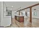 Large kitchen with stainless appliances, quartz countertops, central island, and views to the living room and stairs at 270 Carrolls Way, Fayetteville, GA 30215