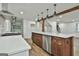 Open kitchen has stainless appliances, white cabinets, and a center island with quartz countertops at 270 Carrolls Way, Fayetteville, GA 30215